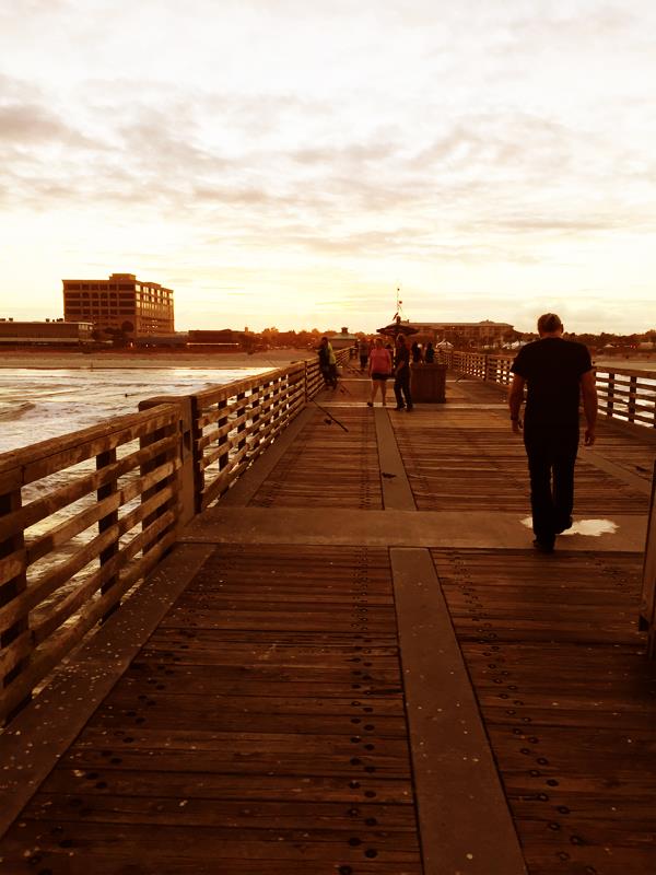 Patrick walking down the Jacksonville Beach Pier. He didn`t love the fishy smell. — at Jacksonville Beach Pier- www.JacksonvilleBeaches.info.
