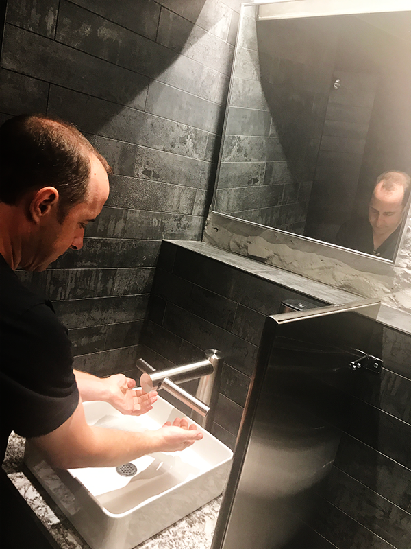 David Below training me on the intricacies of the combo sink-hand-dryer at the The Merchant Ale House — in St. Catharines.