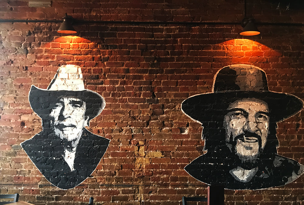Merle Haggard & Waylon Jennings on the wall at the The Westport Saloon — in Kansas City, Missouri.