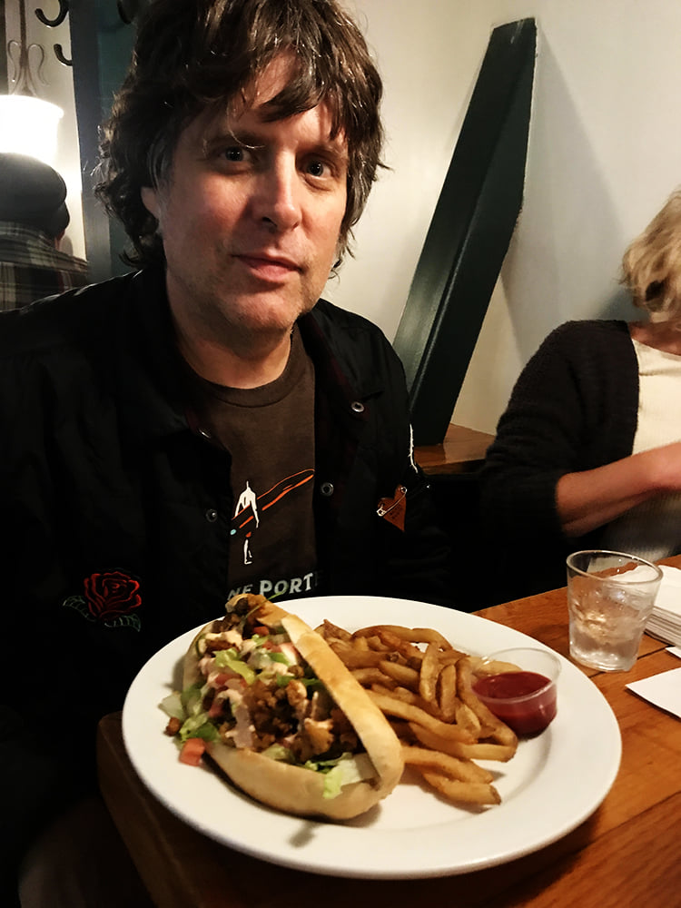 Happy dude with a fried clam Po` Boy from Andy`s Old Port Pub.