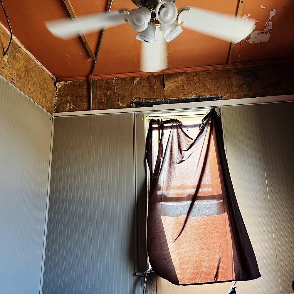 Yorkville Apartment window and ceiling fan, with old map wallpaper, 7am.